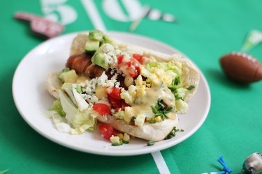 Mustard vinaigrette on top of Cobb salad hot dog