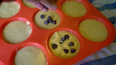 Topping peanut butter banana blender muffin batter with chocolate chips