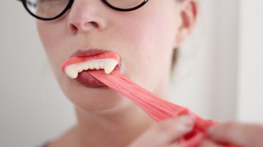 Tasting edible slime while wearing gummy vampire teeth