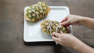 Tying pineapple planks around chicken