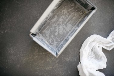 Let the parchment paper slightly overhang the loaf tin.