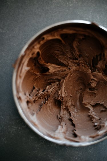 The buttercream will be slightly lightened in colour and fluffy when it is ready.