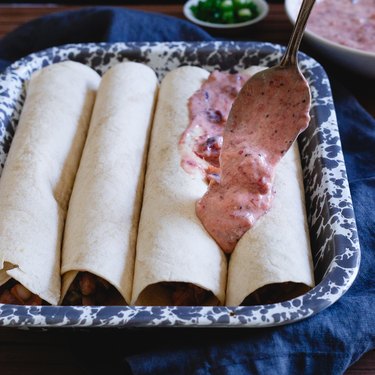 Cranberry salsa sour cream enchilada sauce tops these Thanksgiving leftover enchiladas