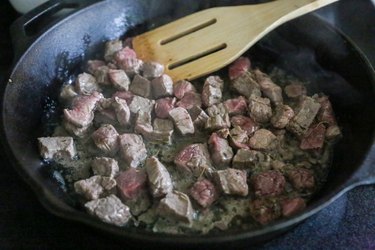 beef cooking in a skillet