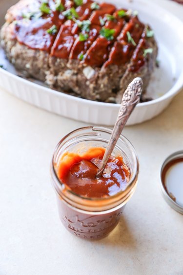 Meatloaf sauce with meatloaf in the background