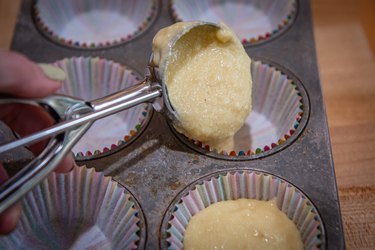 Scooping mixture into cupcake papers