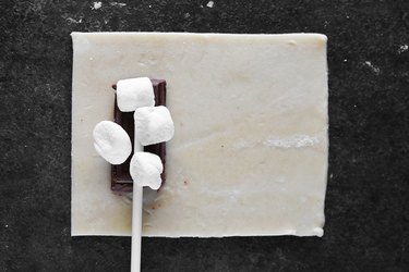 Add marshmallows and lollipop sticks