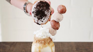 Adding donuts and donut holes to milkshake.