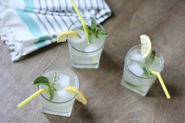 Three glasses of sparkling lemonade with mint garnish