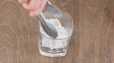 adding ice to cocktail glass