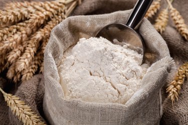 Flour in a bag on the table and spikelets