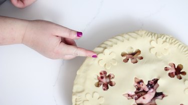 Pressing forefinger into dough to create rope pattern