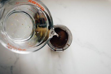 Pour the vodka into the glass jar with the chocolate.