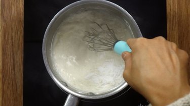 Heating heavy cream and powdered sweetener for low carb truffles.