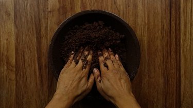 Pressing no-bake gluten free chocolate almond crust into pie pan.