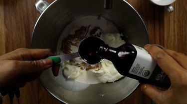 Mixing ingredients for no-bake peanut butter cream cheese pie filling.