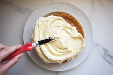 Generously frost the top of the cake.