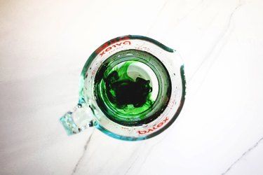 Test the green food coloring by placing a few drops in a jug of water.
