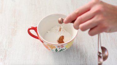 adding dry ingredients to mug