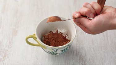 adding dry ingredients to mug