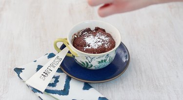 dusting top of cake with powdered sugar