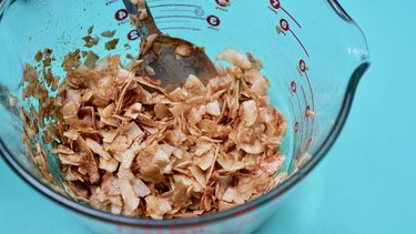 Baking coconut chips to make coconut bacon.