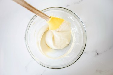 Melted white chocolate set in a bowl to cool.