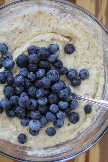 Pancake batter in a bowl with blueberries