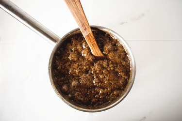 Bubbling and thick caramel mixture in a heavy saucepan.