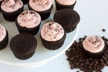 Aerial view of chocolate cupcakes with strawberry frosting