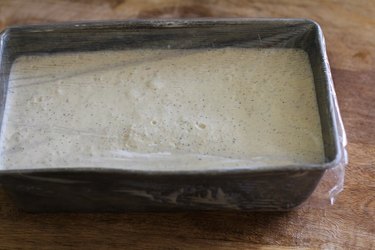 Pan of ice cream base covered with plastic wrap.