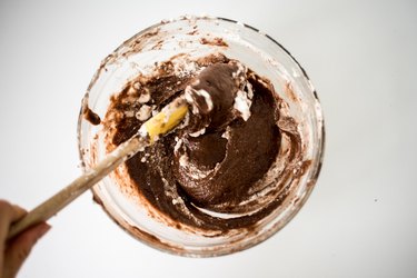 Spatula stirring together egg mixture and dry ingredients.