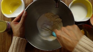 Whisking dry ingredients for healthy coconut flour donuts.