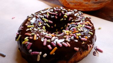 Healthy coconut flour low carb chocolate covered donut with sprinkles.