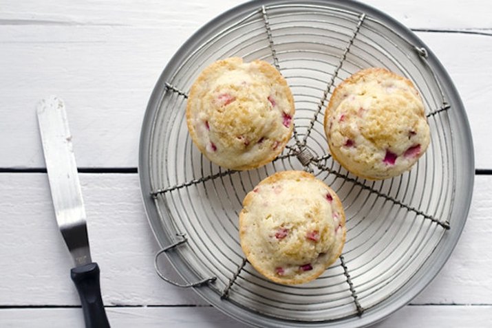 Three muffins on a round wire rack.