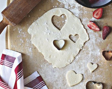 Cutting out dough with heart-shaped cookie cutters