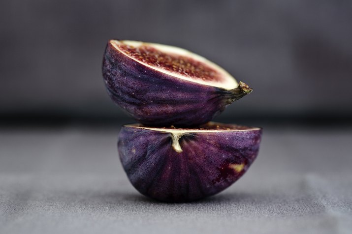 Two halves of a fig, one on top of the other