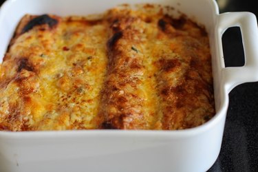 Casserole dish with baked enchiladas.