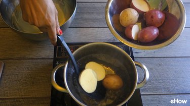 Blanching potatoes before freezing.