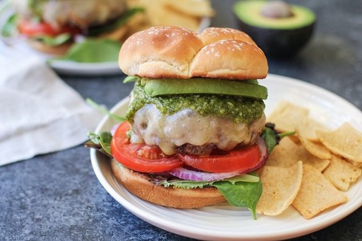 A large gourmet hamburger on a white plate