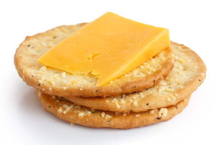 Three golden cheese crackers on white. With cheese.