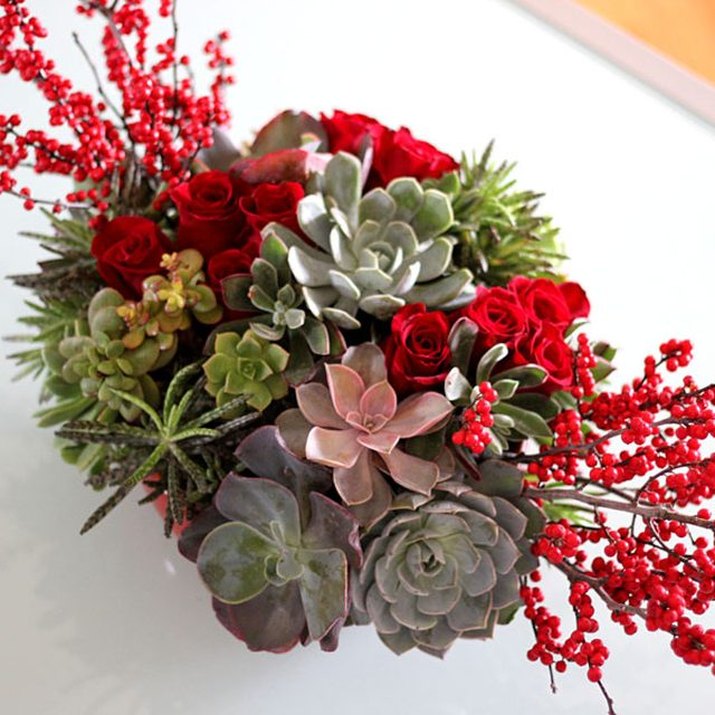 Add berries and flowers to your succulents for a colorful display of holiday cheer.