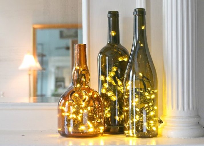 Christmas lights in empty wine bottles create cheerful holiday luminaries.