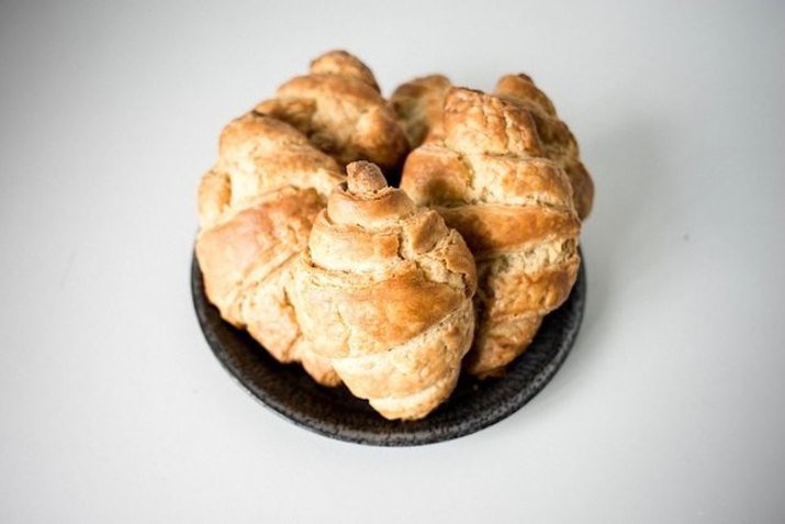 Classic croissants on a grey dish.