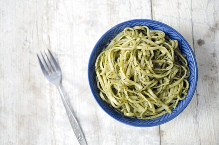 A bowl of linguine tossed with fresh, homemade pesto sauce.