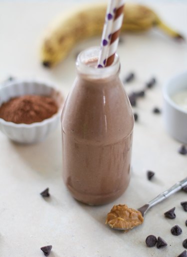 Chocolate shake in a glass with two straws